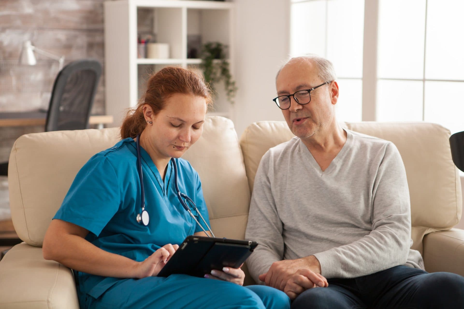A nurse speaking with an older person in a care setting
